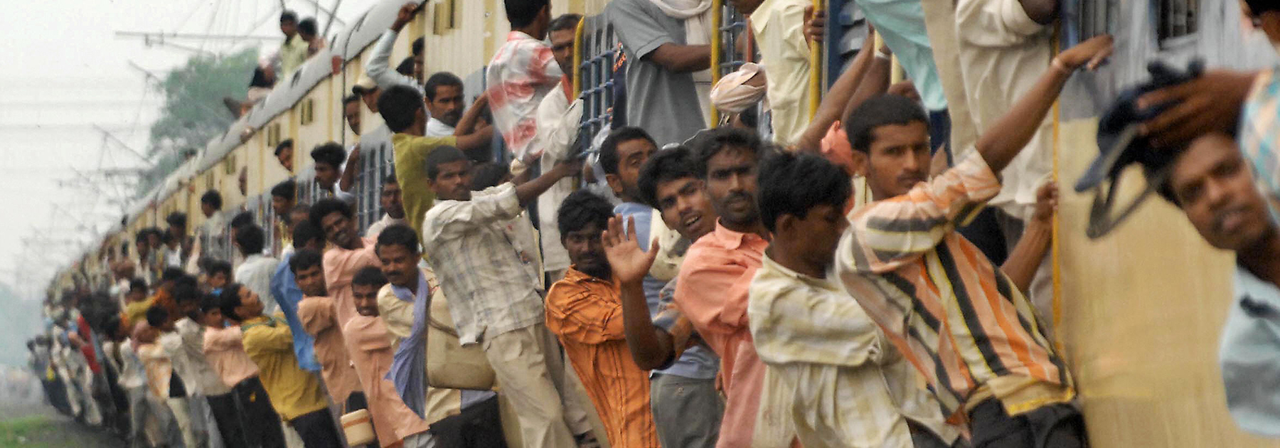 Commuters overcrowd a local passenger train on the Patna-Gaya railway track in Patna. (STR/AFP/Getty Images)