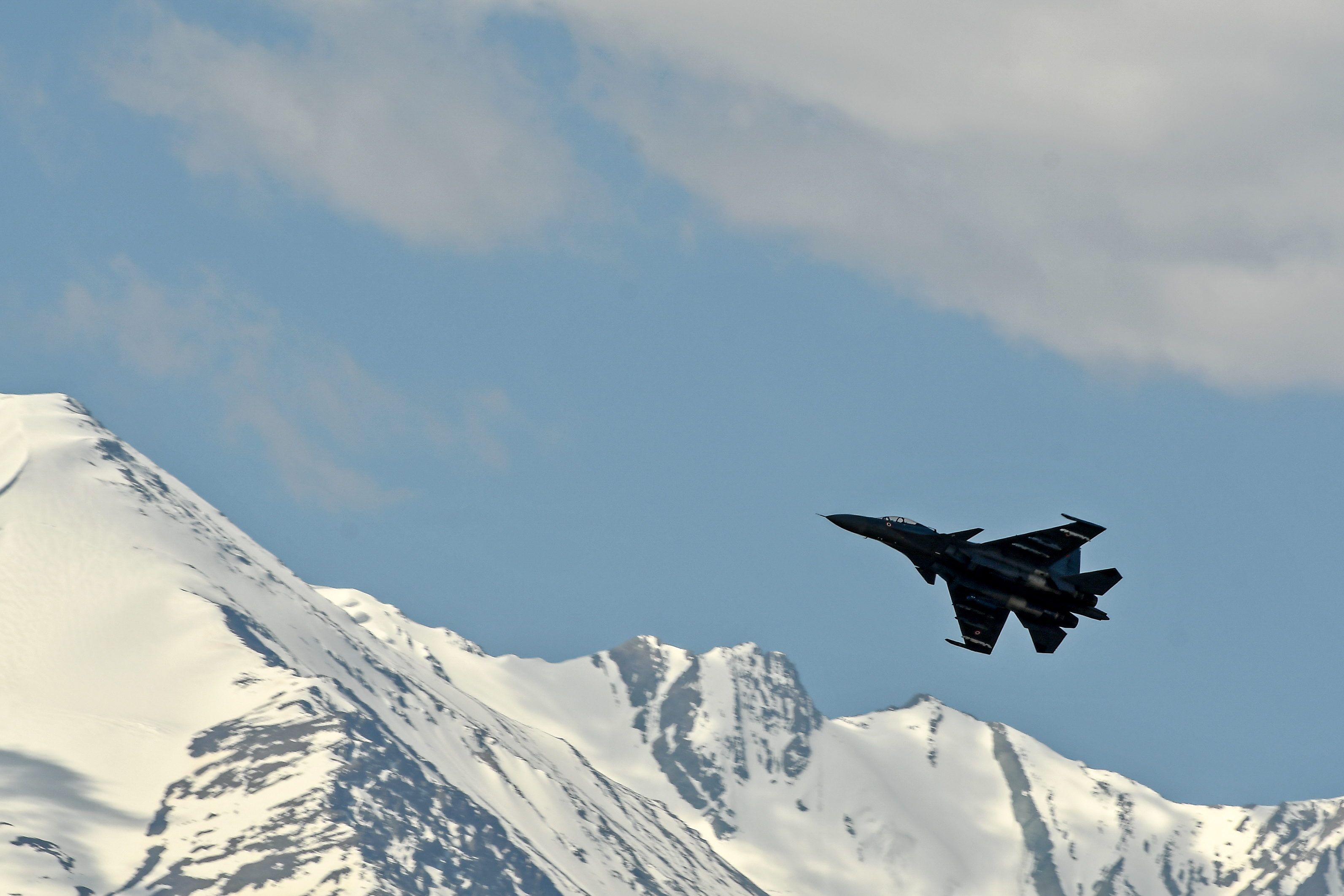 An Indian Air Force aircraft is seen against the backdrop of mountains surrounding Leh, the joint capital of the union territory of Ladakh, on June 27, 2020. (TAUSEEF MUSTAFA/AFP via Getty Images)