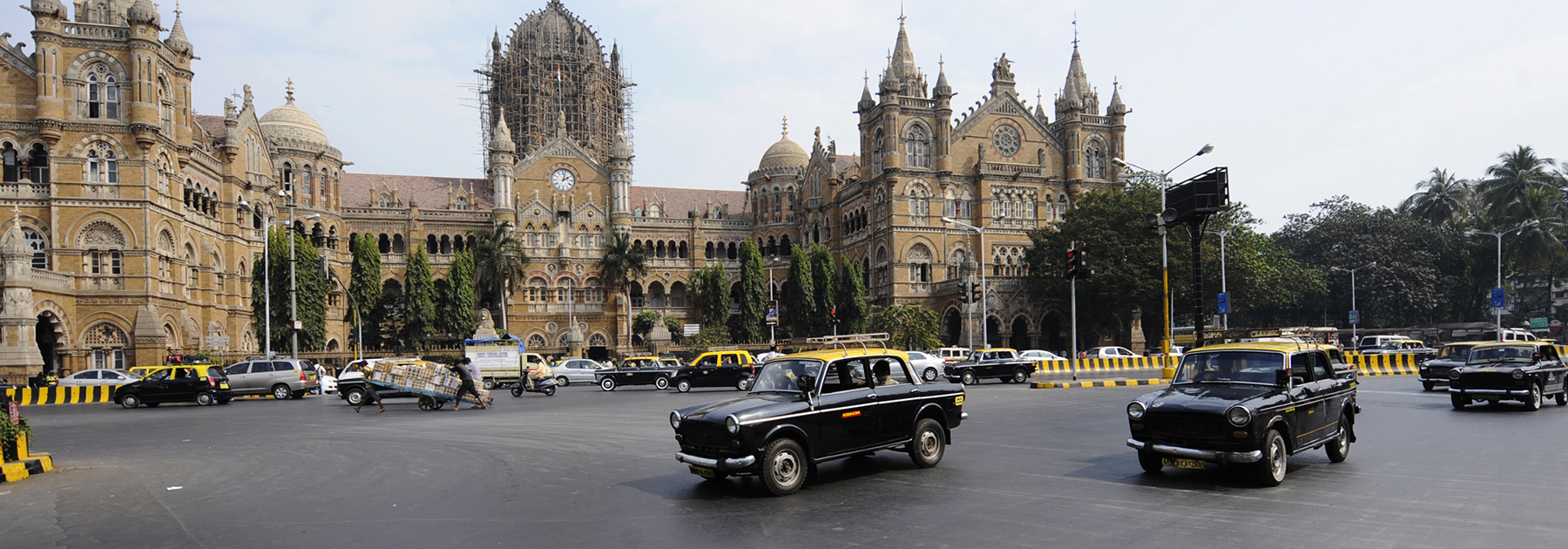 Compressed Natural Gas (CNG) taxis are driven past Chhatrapati Shivaji (Victoria) Terminus train station in Mumbai. (SAJJAD HUSSAIN/AFP/Getty Images)