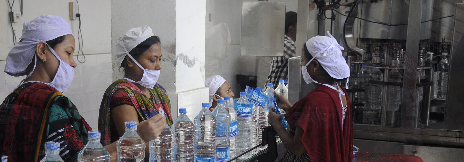 Workers add labels onto bottles of drinking water at a bottling unit on World Water Day in Agartala. (ARINDAM DEY/AFP/Getty Images)